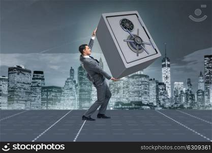 Businessman carrying metal safe in security concept