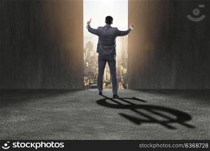 Businessman casting dollar shape shadow in business concept