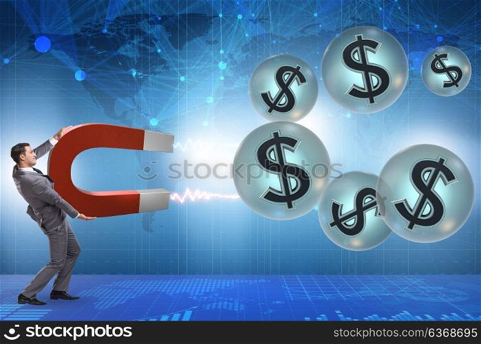 Businessman catching dollars on horseshoe magnet