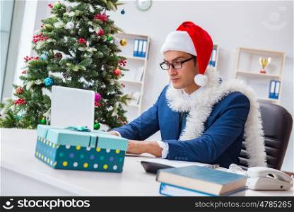 Businessman celebrating christmas holiday in the office