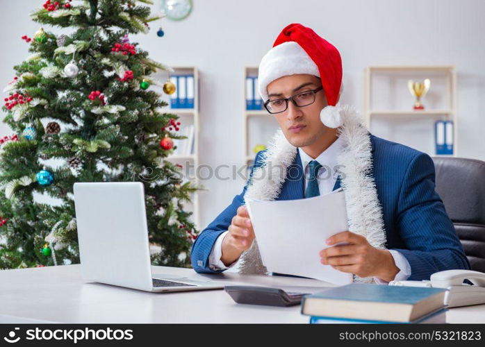 Businessman celebrating christmas holiday in the office