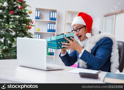 Businessman celebrating christmas holiday in the office