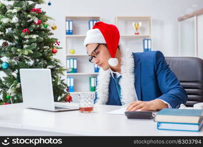 Businessman celebrating christmas holiday in the office