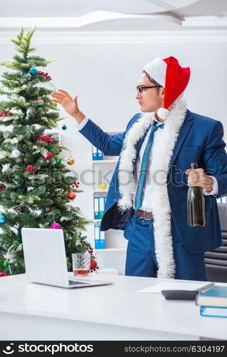 Businessman celebrating christmas holiday in the office