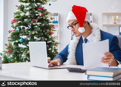 Businessman celebrating christmas holiday in the office