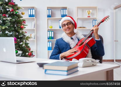 Businessman celebrating christmas holiday in the office