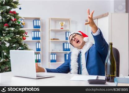 Businessman celebrating christmas holiday in the office