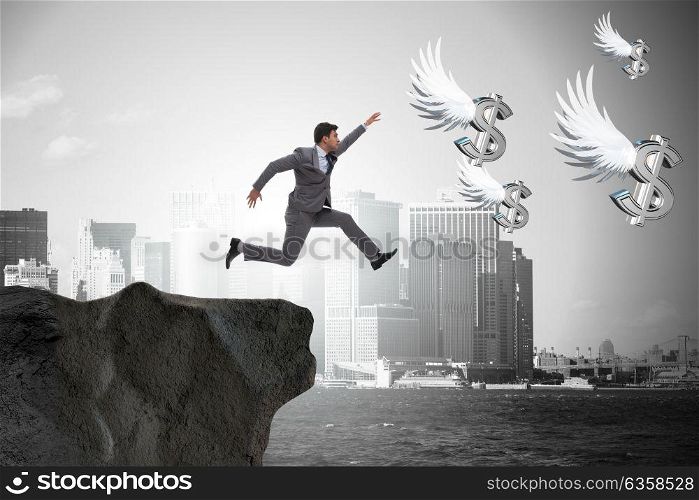 Businessman chasing angel dollars in business concept. The businessman chasing angel dollars in business concept
