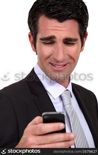 Businessman checking e-mail on cellphone