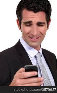 Businessman checking e-mail on cellphone
