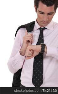 Businessman checking his watch for the time