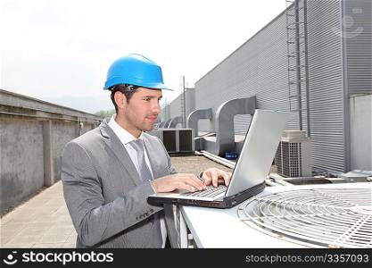 Businessman checking industrial installation