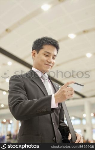 Businessman Checking the Ticket