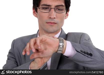 Businessman checking time on wrist watch