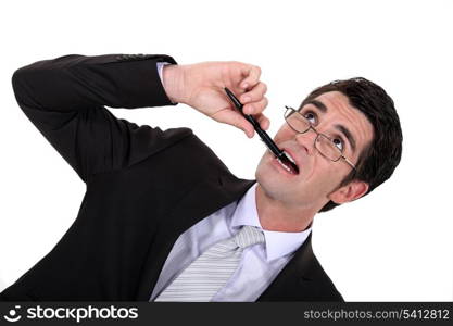 Businessman chewing his pen