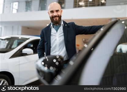 Businessman choosing transport in car dealership. Customer in new vehicle showroom, male person buying automobile, auto dealer business. Businessman choosing transport in car dealership