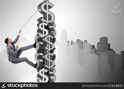 Businessman climbing dollar challenge tower