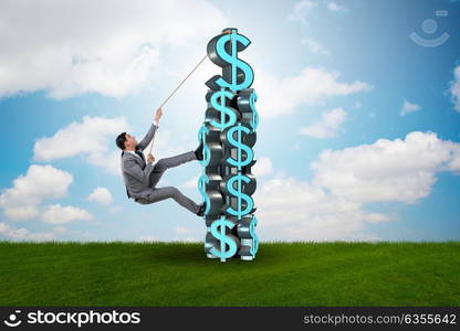 Businessman climbing dollar challenge tower