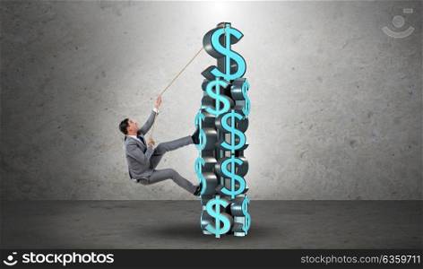 Businessman climbing dollar challenge tower