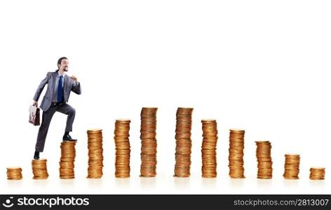 Businessman climbing gold coins stacks