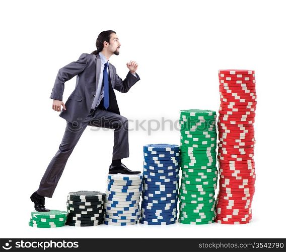 Businessman climbing stacks of casino chips