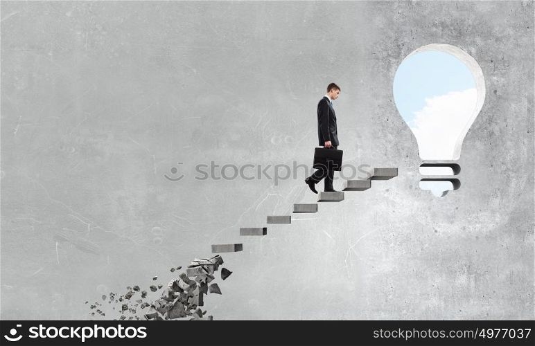 Businessman climbing stone ladder . Young businessman walking up collapsing staircase representing success concept