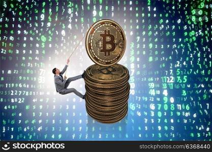 Businessman climbing the stack of bitcoins
