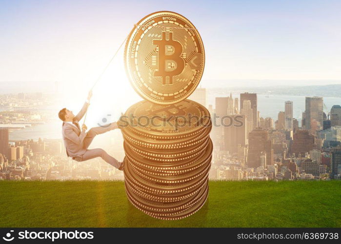 Businessman climbing the stack of bitcoins