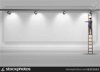 Businessman climbing the wall lit with spotlights. The businessman climbing the wall lit with spotlights
