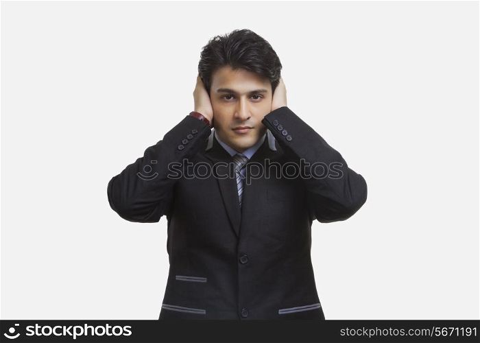 Businessman closing his ears