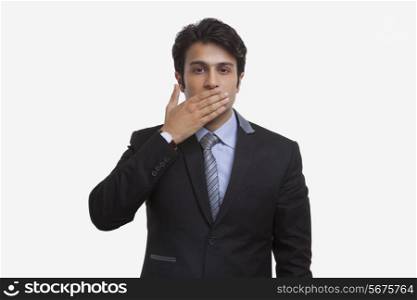 Businessman closing his mouth