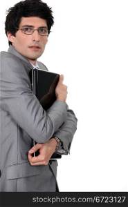 Businessman clutching his laptop