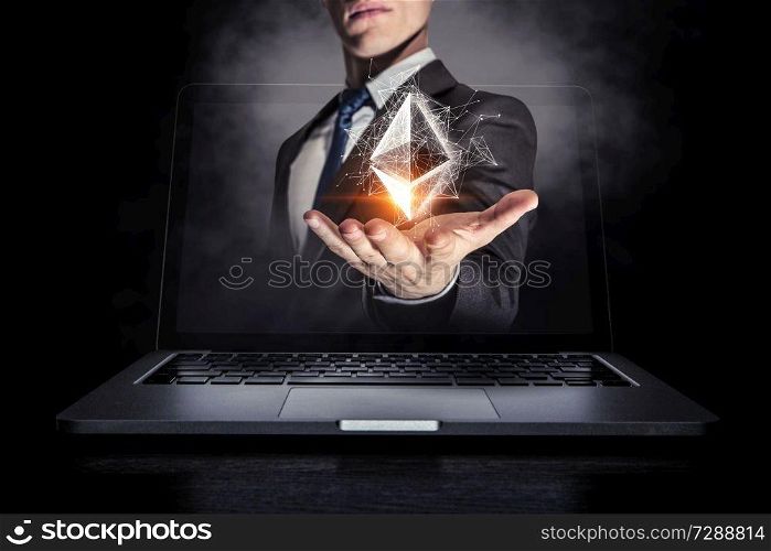 Businessman coming out of laptop screen presenting ethereum icon. 3d rendering. Crypto currency market. Mixed media