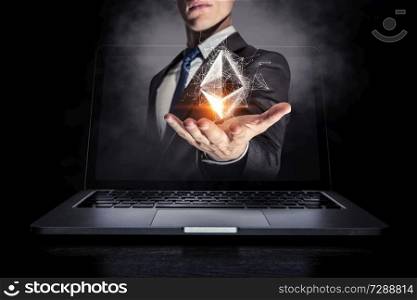 Businessman coming out of laptop screen presenting ethereum icon. 3d rendering. Crypto currency market. Mixed media