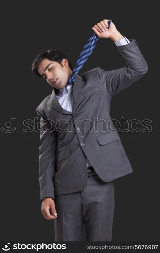 Businessman committing suicide against black background