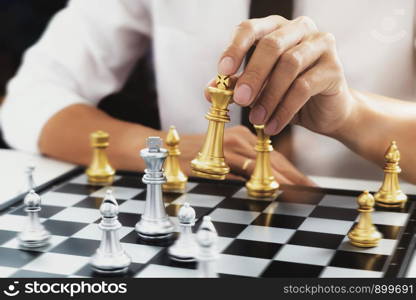 Businessman competition in chess board game.