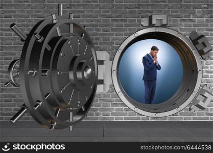 Businessman concerned about theft at banking vault door