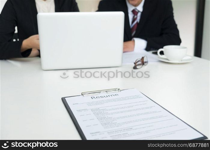 Businessman conducting an interview with businessman in an office.