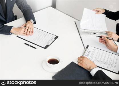 Businessman conducting an interview with businessman in an office.