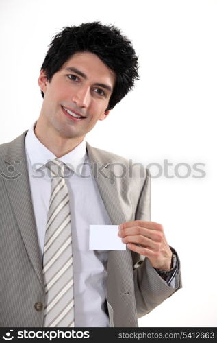 Businessman confidently presenting card