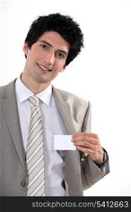 Businessman confidently presenting card