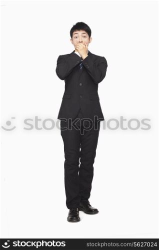 Businessman covering mouth with hands