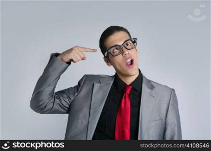 Businessman crazy with funny glasses and suit on gray background