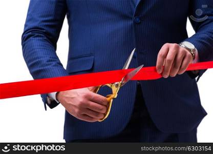 Businessman cutting red ribbon isolated on white