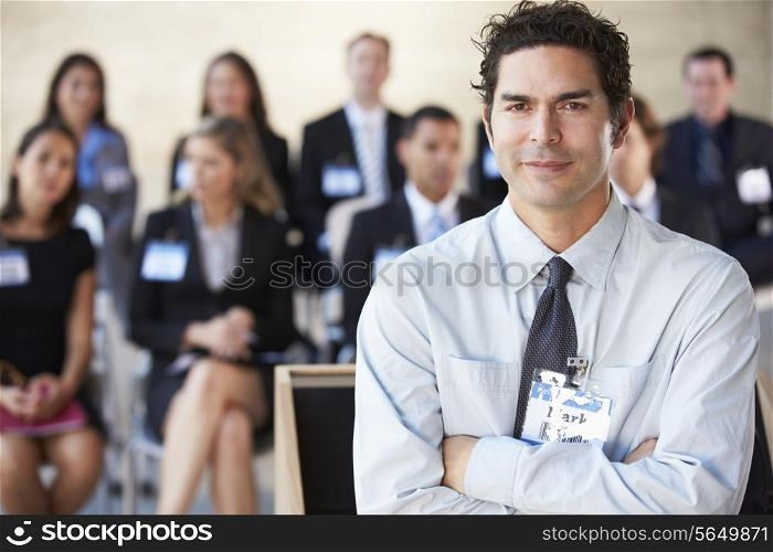 Businessman Delivering Presentation At Conference
