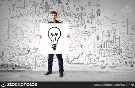 Businessman demonstrating banner with ideas. Young businessman holding banner with good idea concept