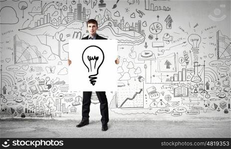 Businessman demonstrating banner with ideas. Young businessman holding banner with good idea concept