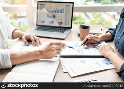 businessman discuss explaining new trends information on a document with colleague co-worker or partner together in a modern business office