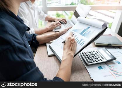 businessman discuss explaining new trends information on a document with colleague co-worker or partner together in a modern business office