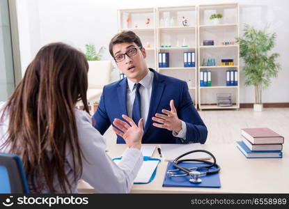 Businessman discussing health issues with doctor